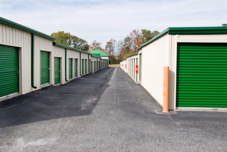 Mini Storage Warehouse Buildings with Green Doors Drop 'N Lock Storage Co. Inc.