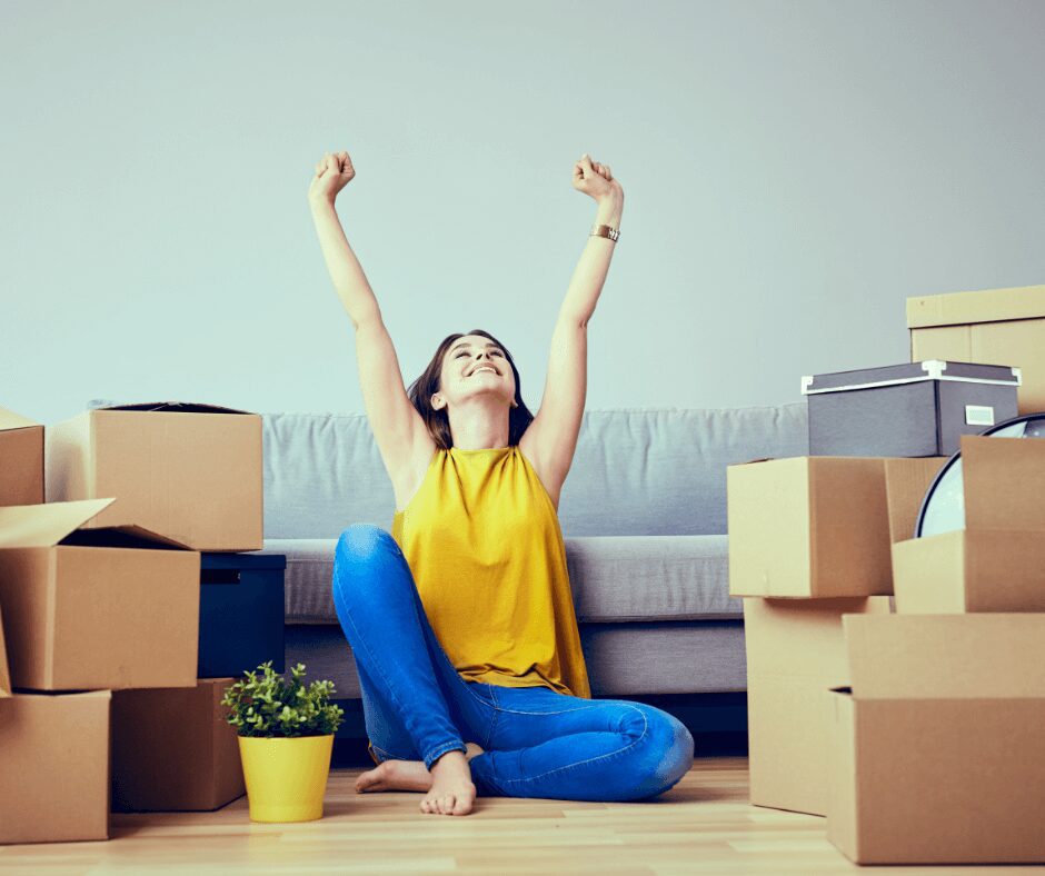 A Woman in Yellow With Cardboard Boxes Around